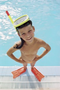 Boy by a swimming pool